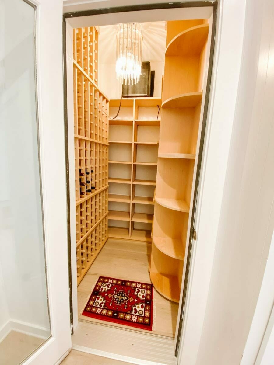 Closet Conversion with Redwood Custom Racks.  Large Format Bottles, room for boxes and angled shelves