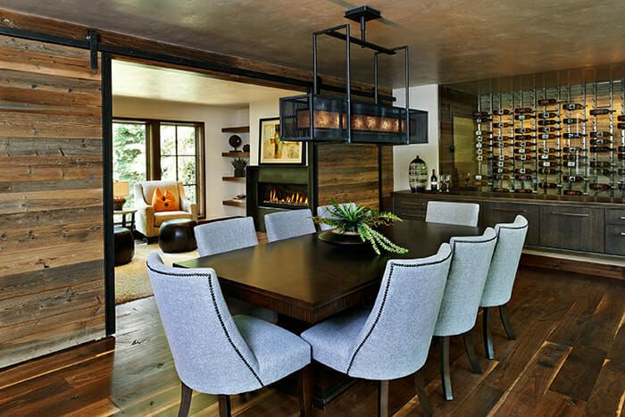 Wooden dining room with table and chairs.