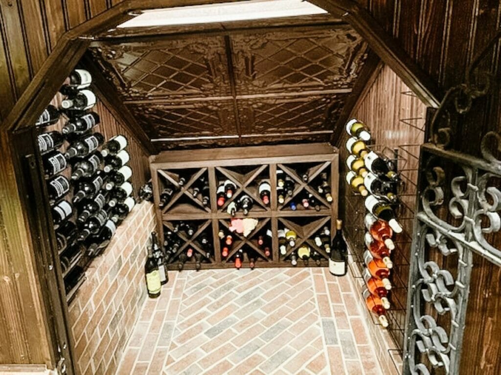 Wine cellar, brick floor, wine bottles.