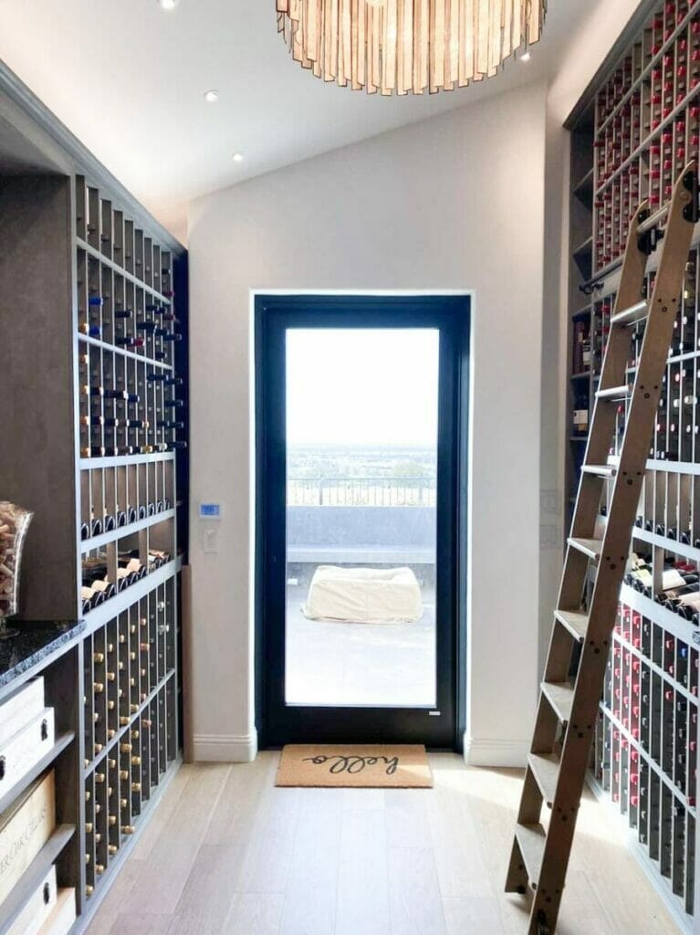 Wine cellar with ladder, wine racks.