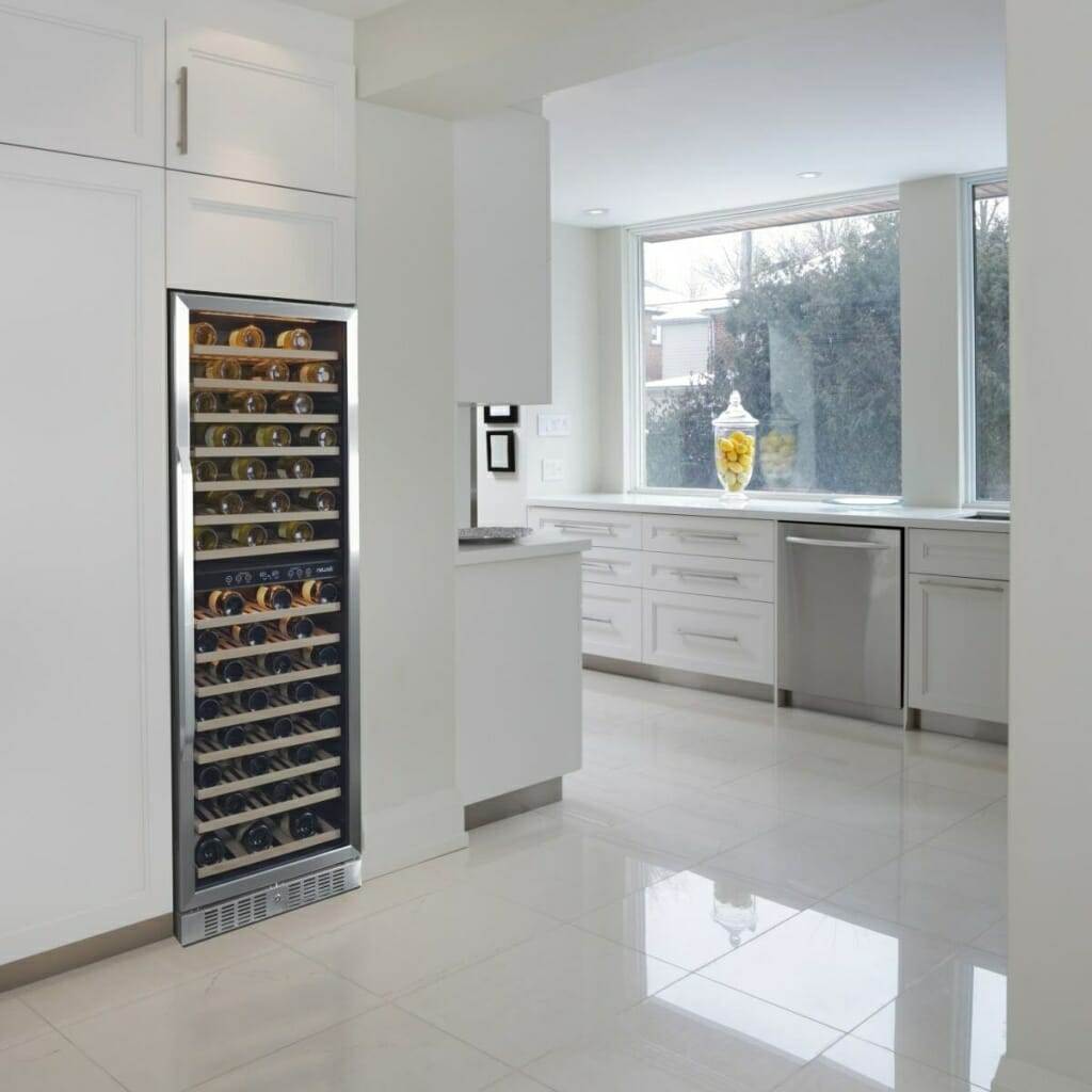 NewAir 27” 160 Bottle Built-in Dual Zone Compressor Wine Fridge in a white kitchen.