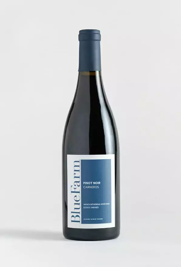 A bottle of 2018 BlueFarms Pinot Noir from Carneros on a white background.