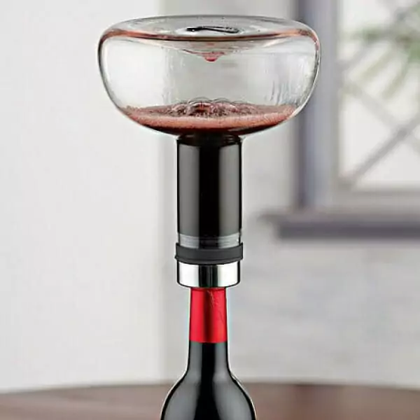 A Menu decanter is sitting on top of a table.