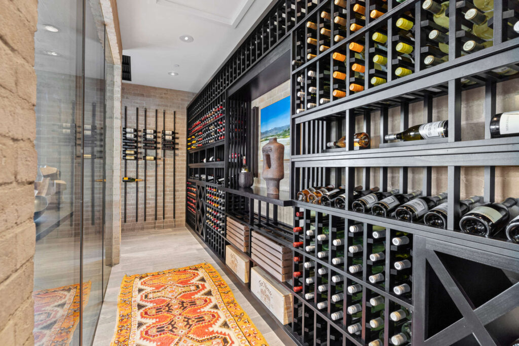 An extensive wine cellar stocked with a wide variety of bottles.