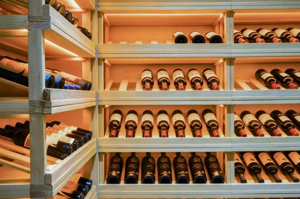 A wine cellar offering a storage solution to wine collectors with custom wine racks holding many bottles of wine.