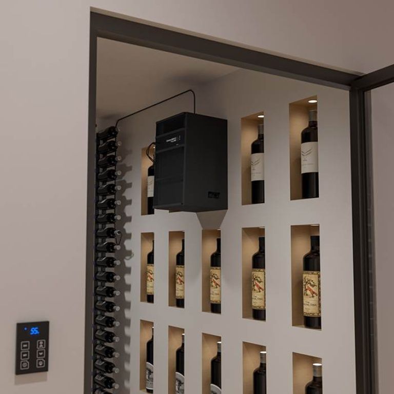 A wine cellar with bottles displayed in a built-in rack. A digital controller on the wall shows a temperature of 56 degrees Fahrenheit. A cooling unit is installed above the wine bottles.