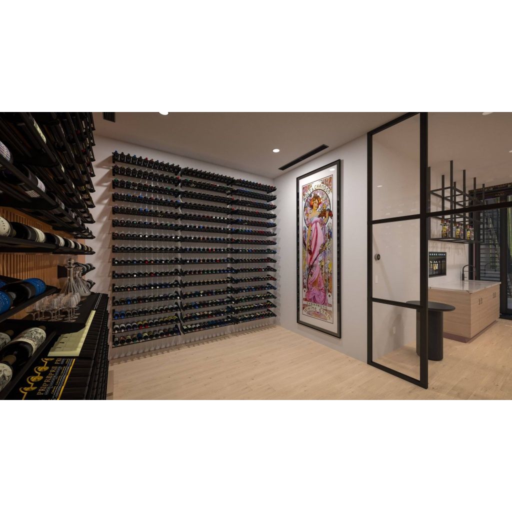 A modern wine cellar with wall-mounted wine racks, a large framed artwork of a woman, wooden flooring, wine bottles on shelves, and a partitioning glass wall with a small counter and sink on the right.