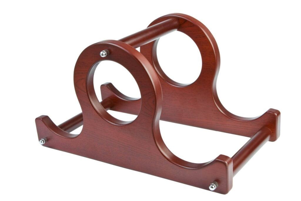 A wooden stand with a glossy finish designed to hold three items, featuring two circular openings and two horizontal bars for support—perfect for those seeking space-saving tips or looking for an elegant wine rack.