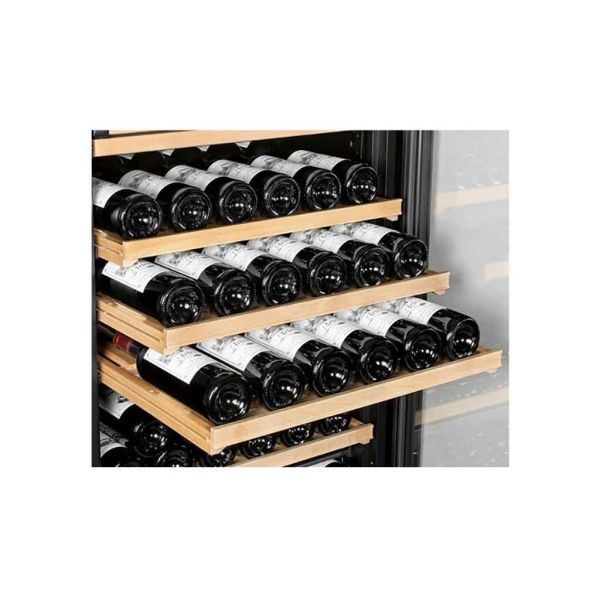 Wine bottles stored horizontally on wooden shelves inside an auto-draft wine cooler.