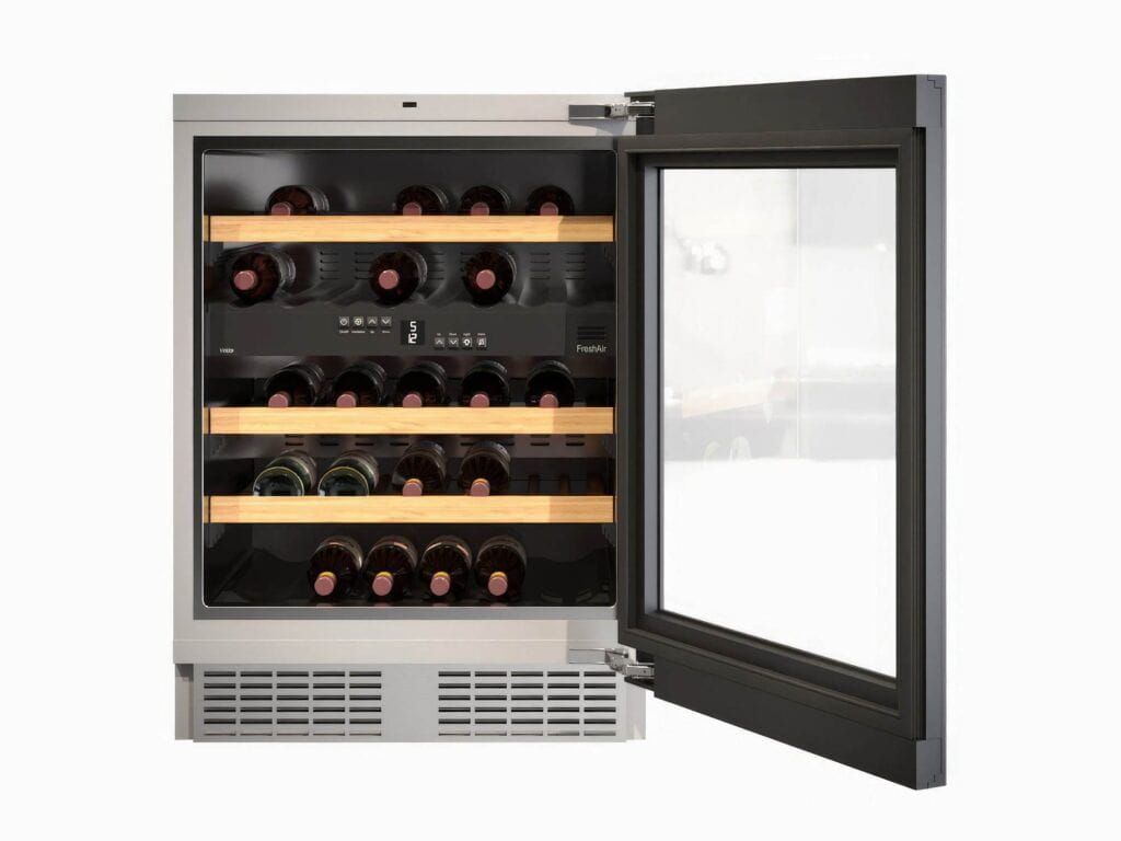 A wine cooler from one of the best brands, featuring a glass door that reveals several bottles of wine on three wooden shelves, is shown with the door partially open.