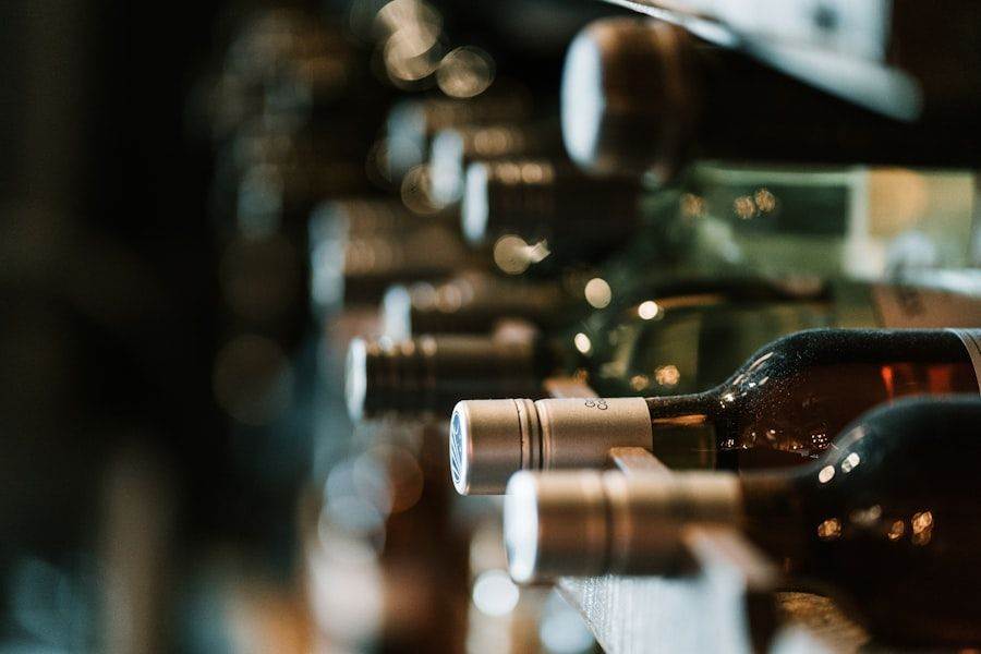 Close-up of wine bottles stored horizontally on a wooden rack, showing necks and caps.