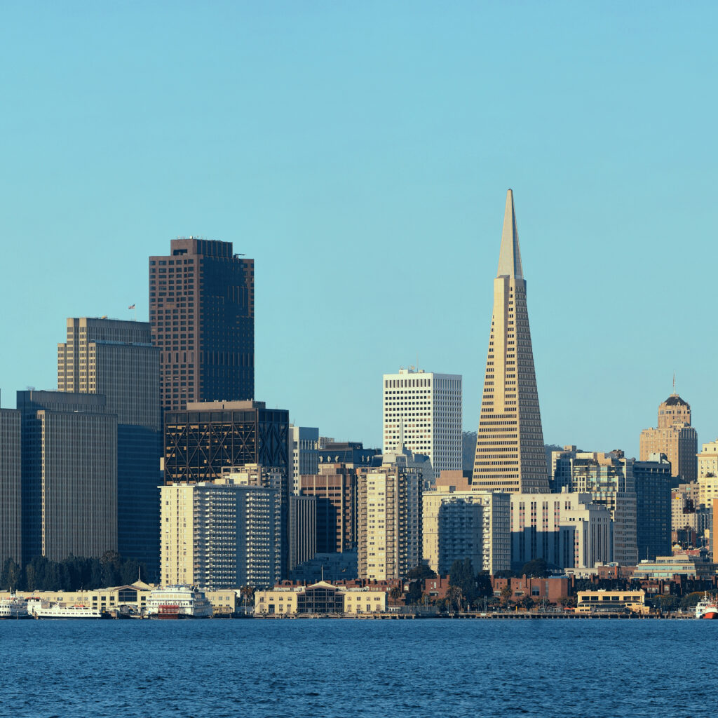 San Francisco skyline with the Transamerica Pyramid and high-rise buildings viewed from across the bay on a clear day—a classic SF Bay Area scene.