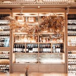 Collection of various wines placed in showcase of modern enoteca with stylish furniture and creative decoration