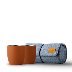 Two brown magnetic tumblers sit before a rolled gray felt pouch with leather patch and black cord—perfect companions for your High Camp Parkside Flask™ 750 Insulated Wine Flask.