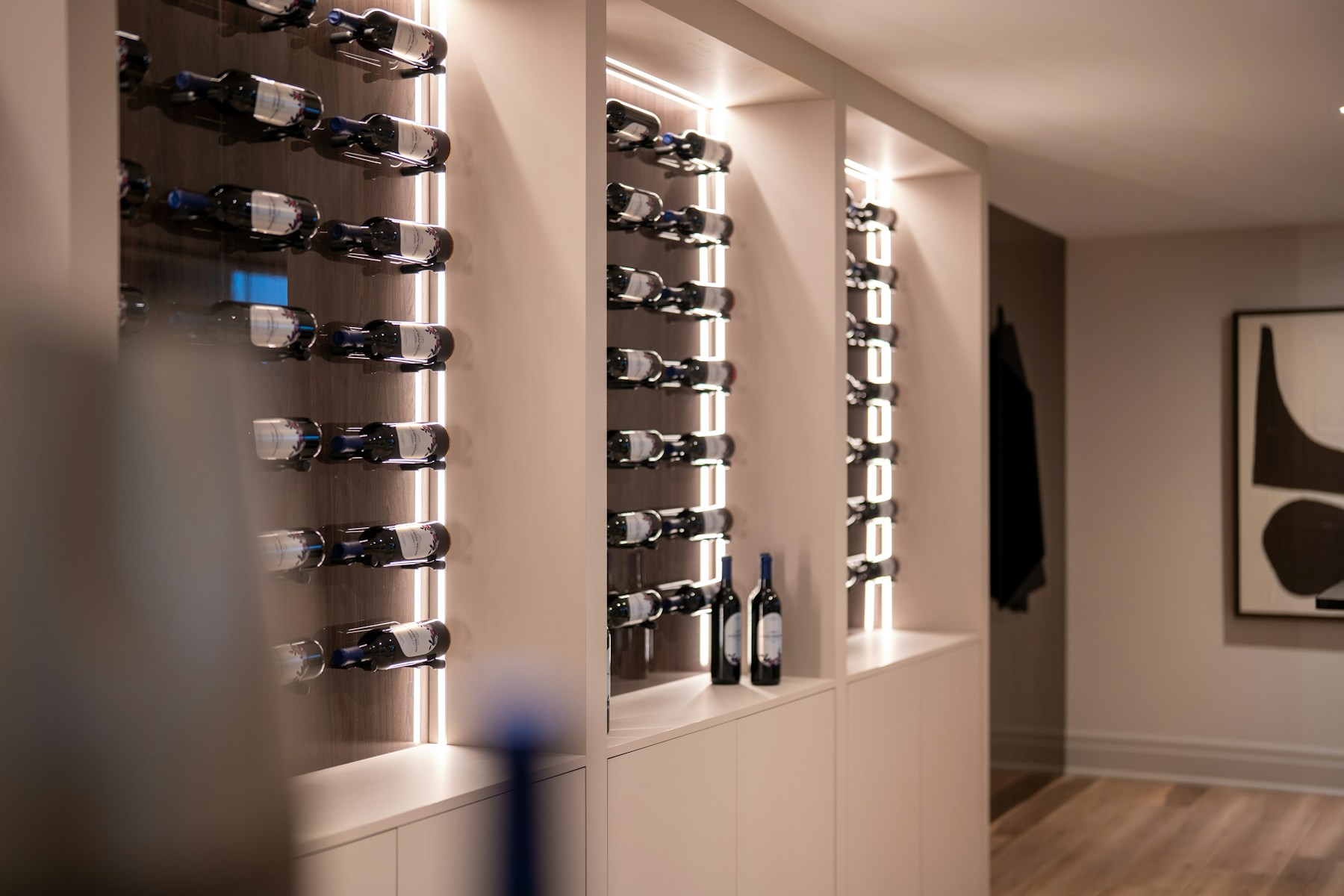 Modern residential wine wall with illuminated bottle display